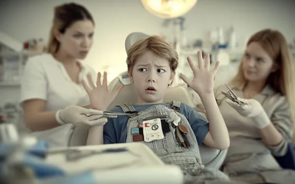 The picture represents a boy with a fear of dentists (dentophobia). The patient experiences extreme stress and is unable to co-operate in the treatment.