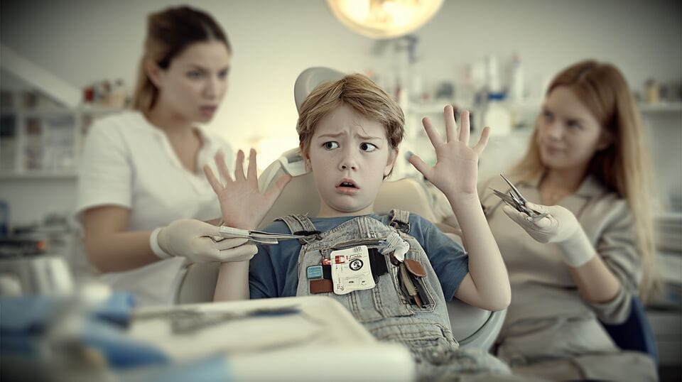 The picture represents a boy with a fear of dentists (dentophobia). The patient experiences extreme stress and is unable to co-operate in the treatment.